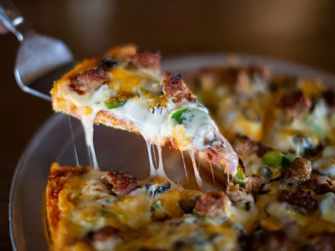 House special pizza with melted cheese pull at Spiro's Pizza & Pasta in Shoreline WA